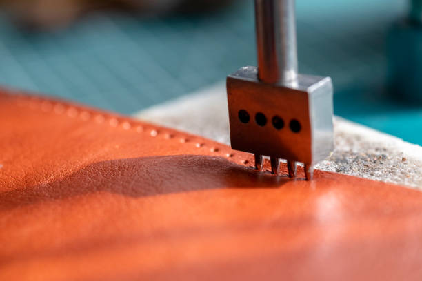 Pricking iron punching evenly spaced stitch holes in leather